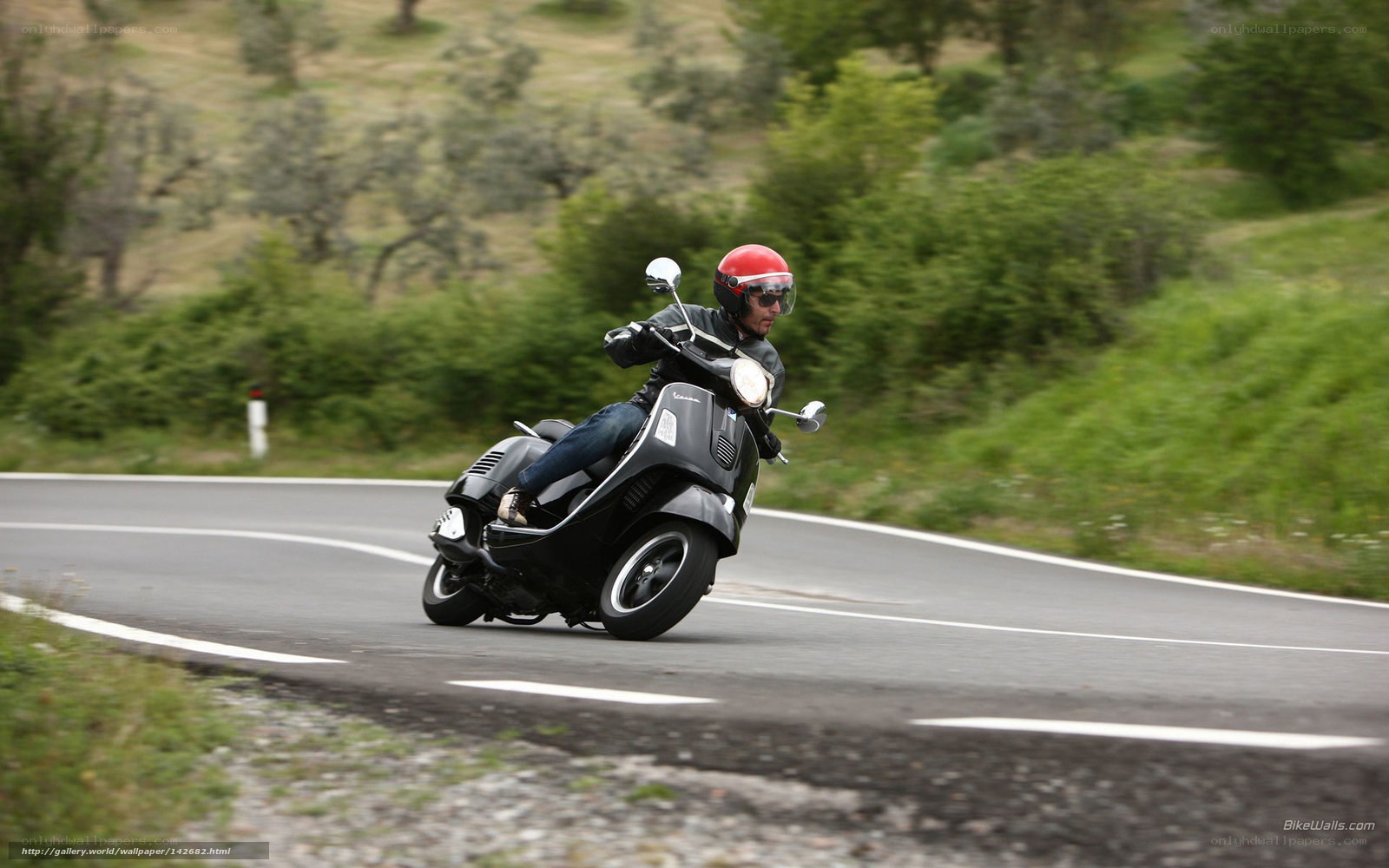 Man riding scooter on winding road