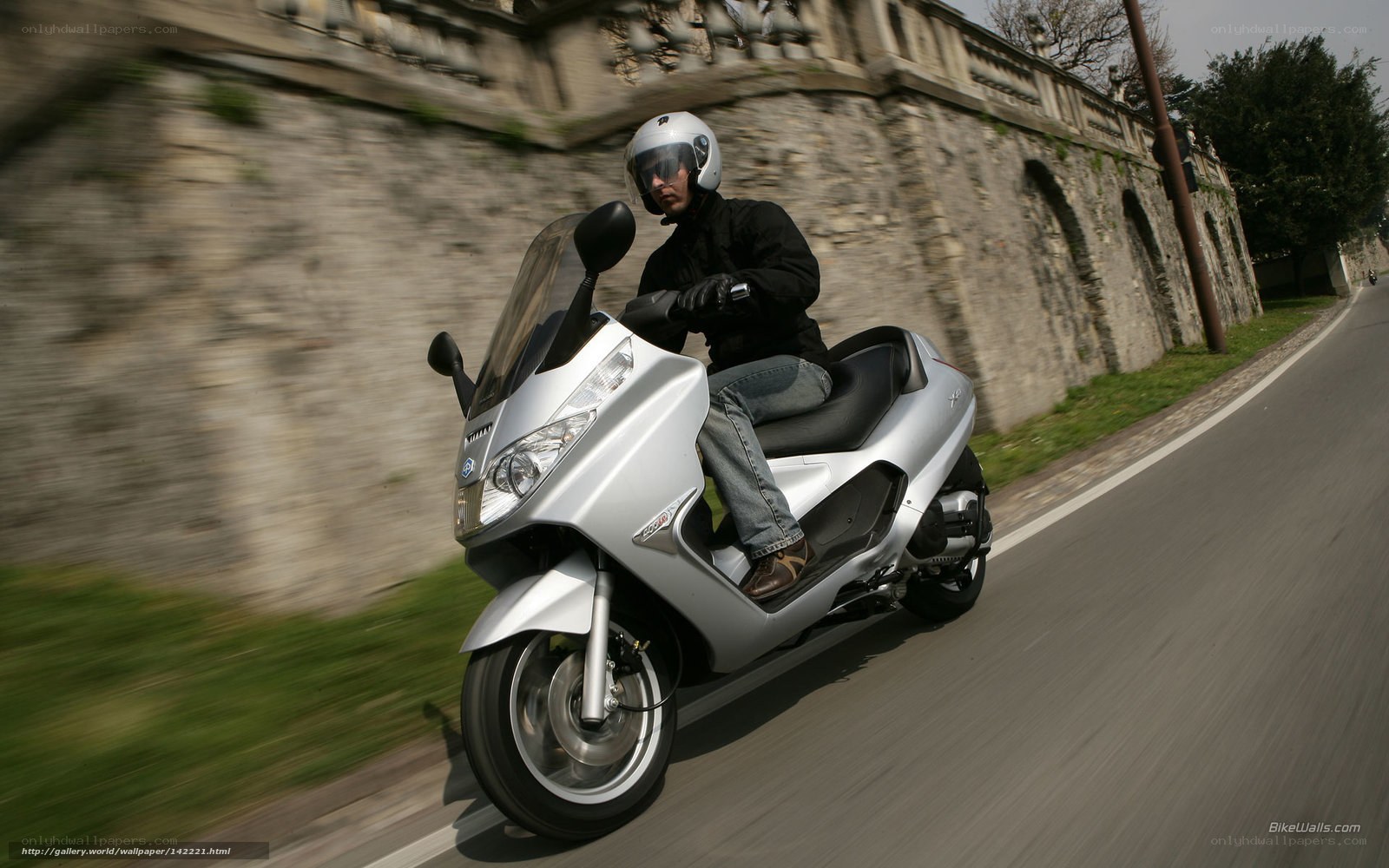 man riding silver scooter