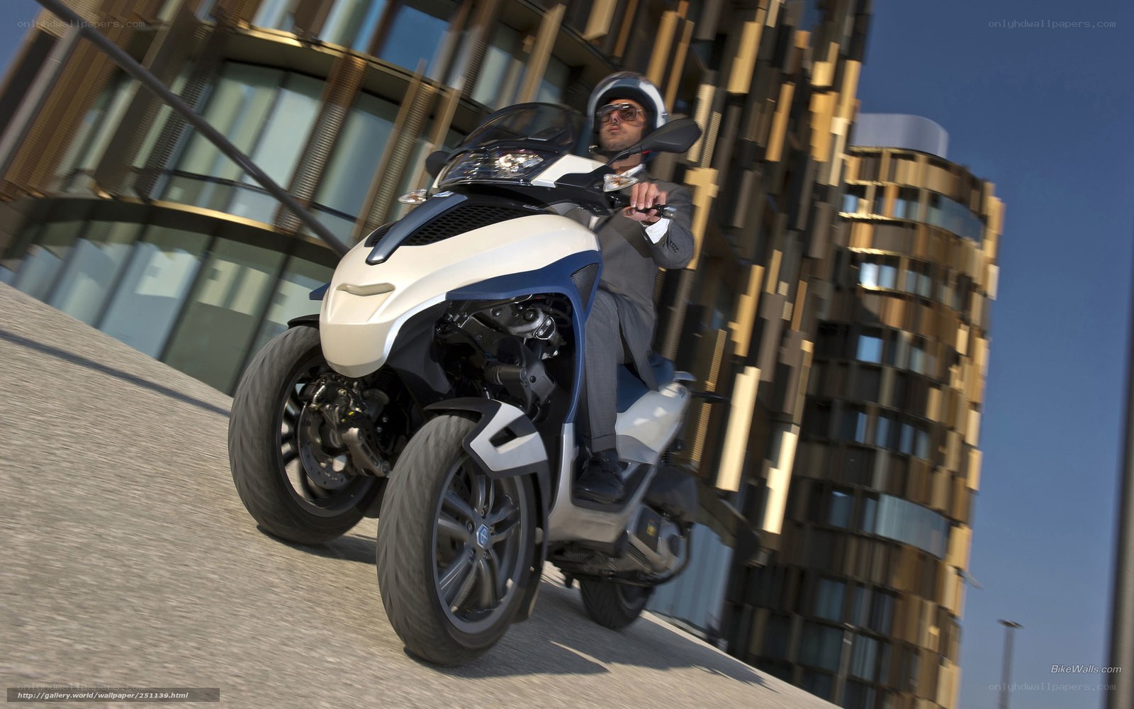 Man riding three-wheeled scooter
