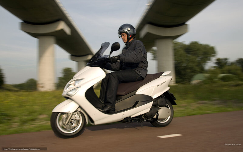 Man riding white scooter