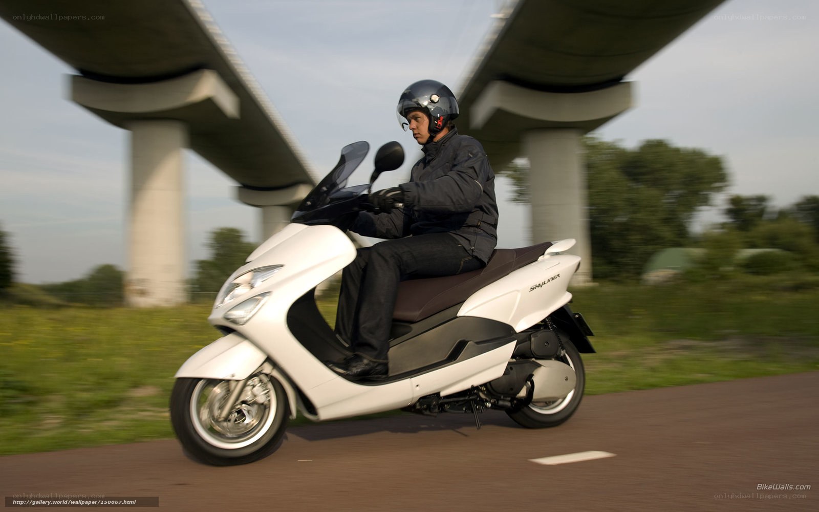 Man riding white scooter