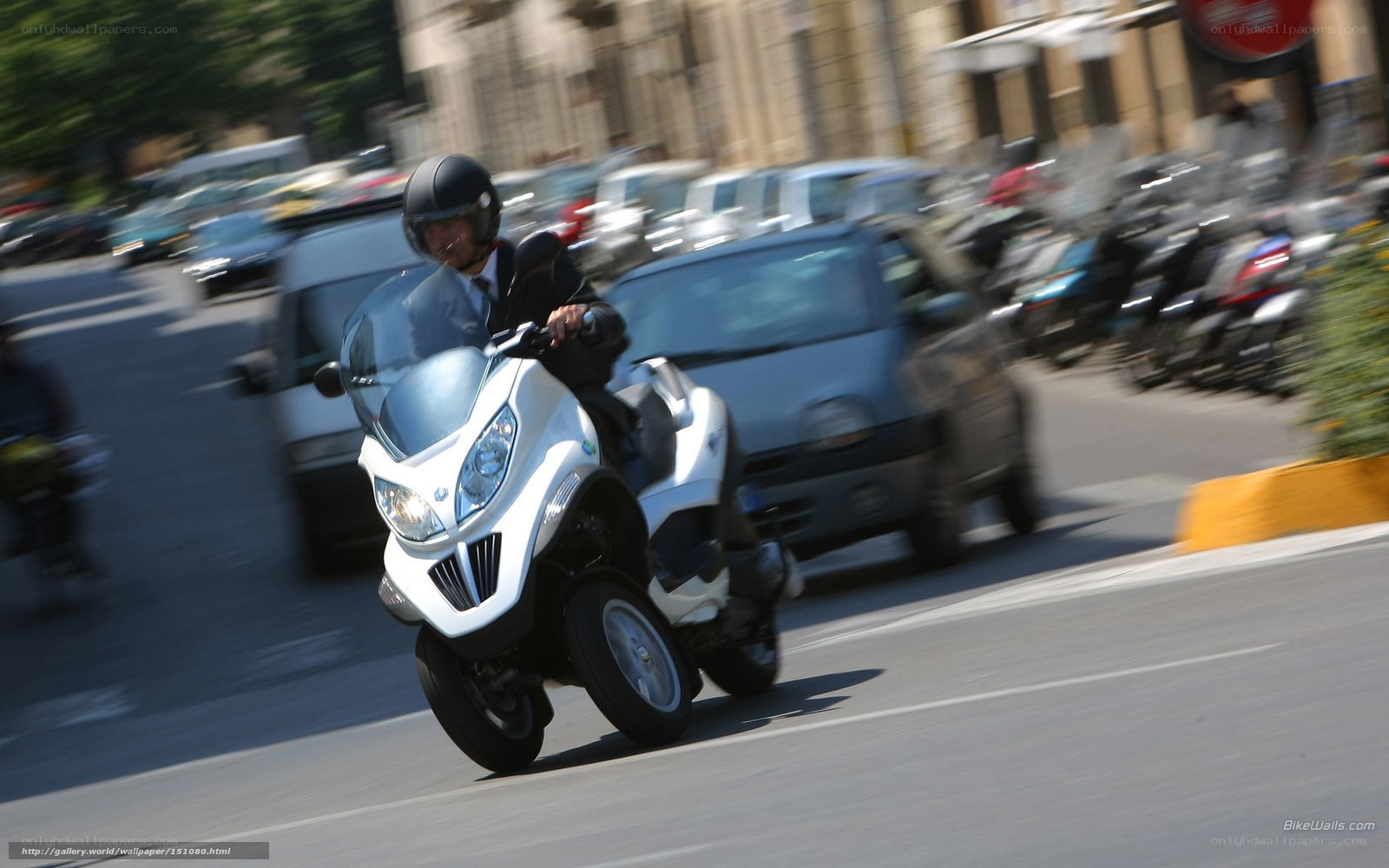 Man riding white scooter in city