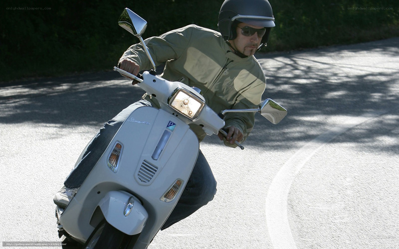 man riding white scooter