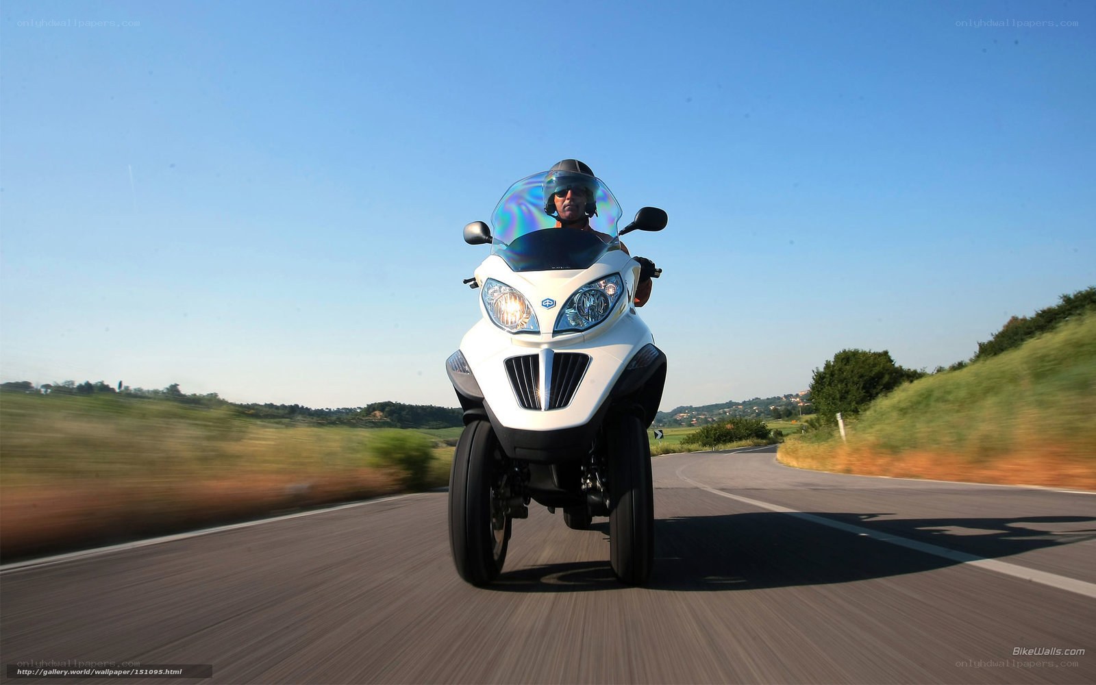 Man riding white three-wheeled motorcycle