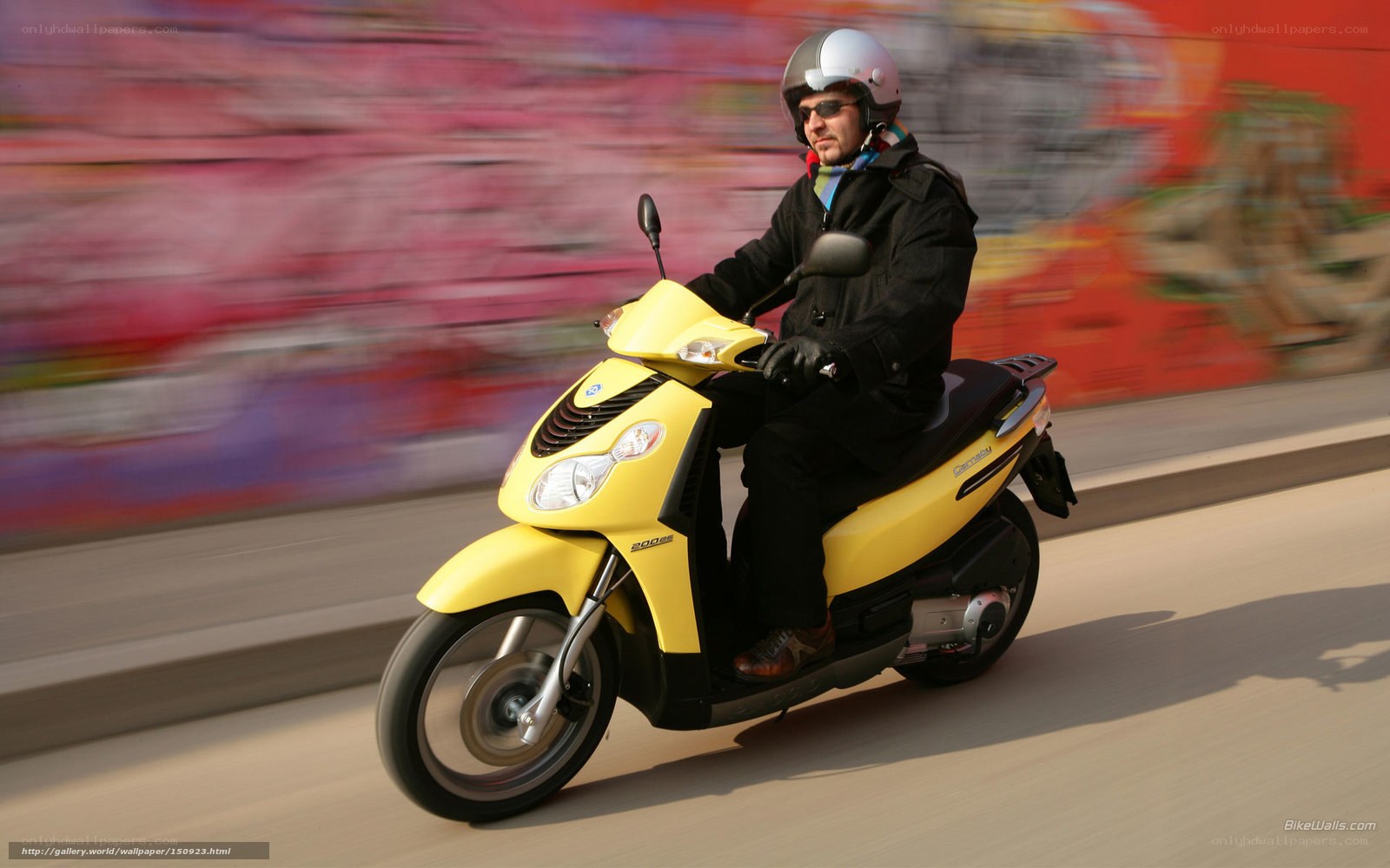 Man riding yellow scooter