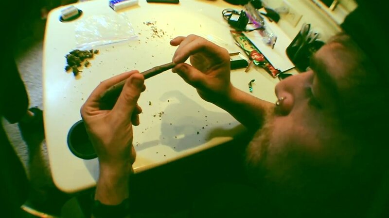 man rolling a cigarette