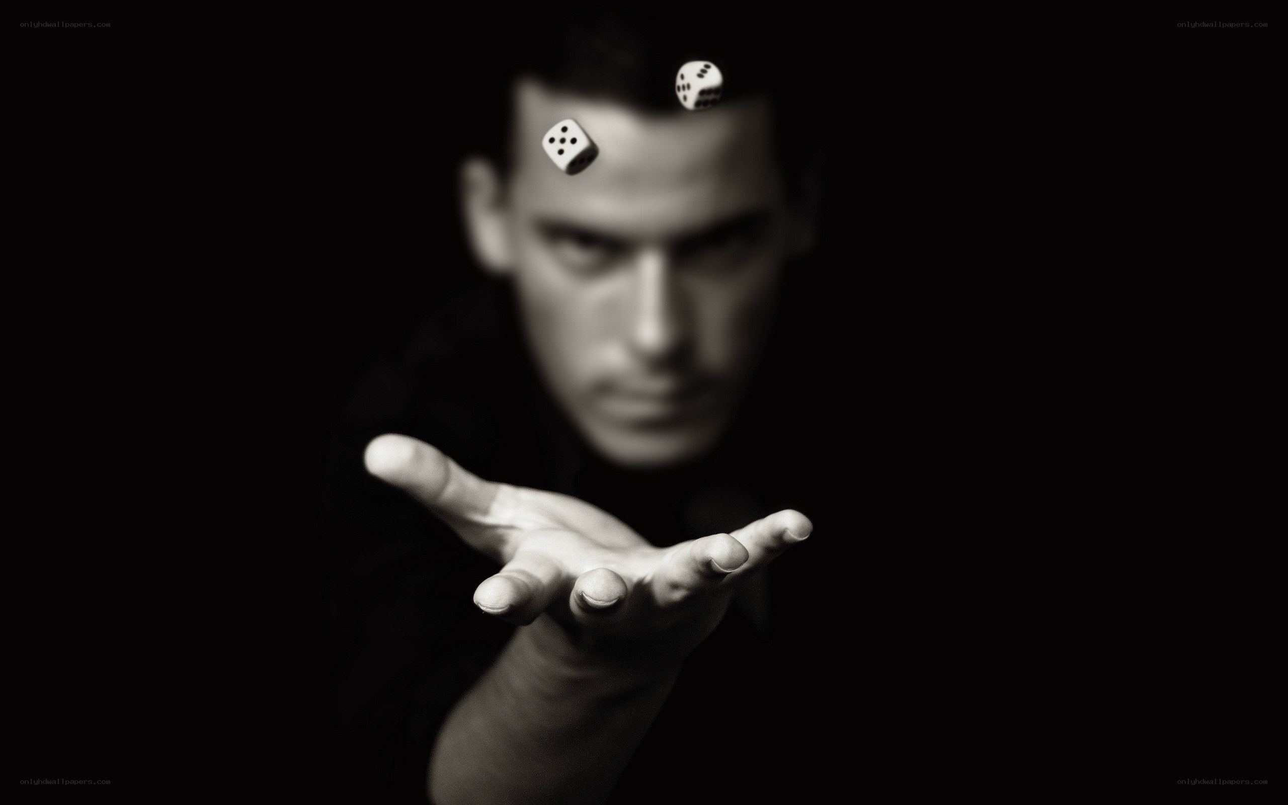 Man rolling dice in black and white