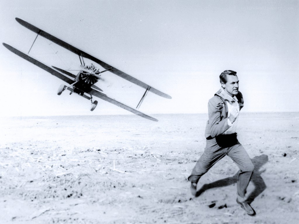 man running from biplane