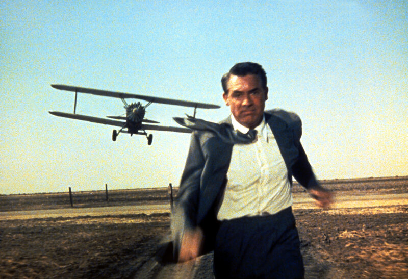Man running from biplane