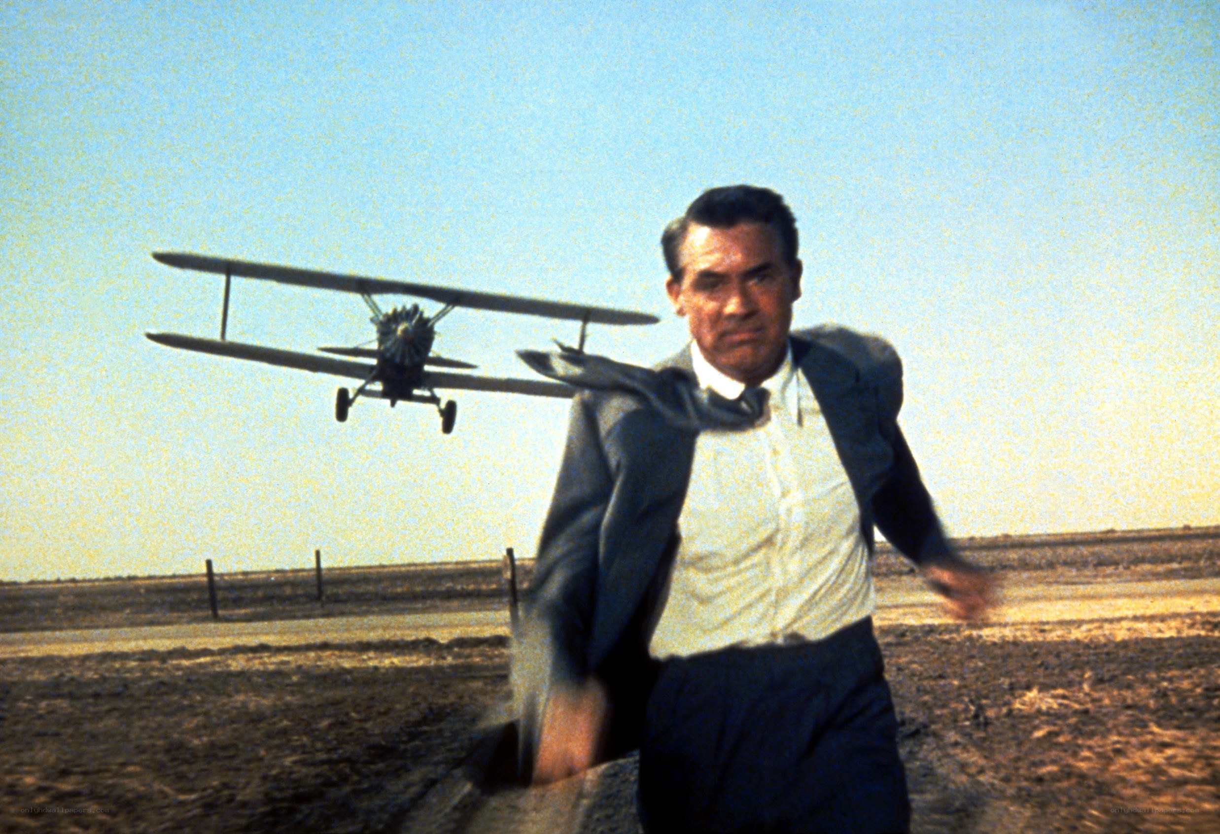 Man running from biplane