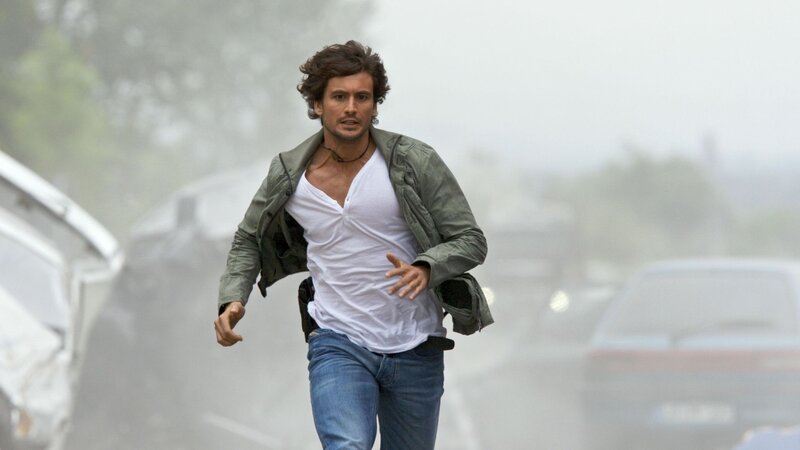 man running in a foggy street