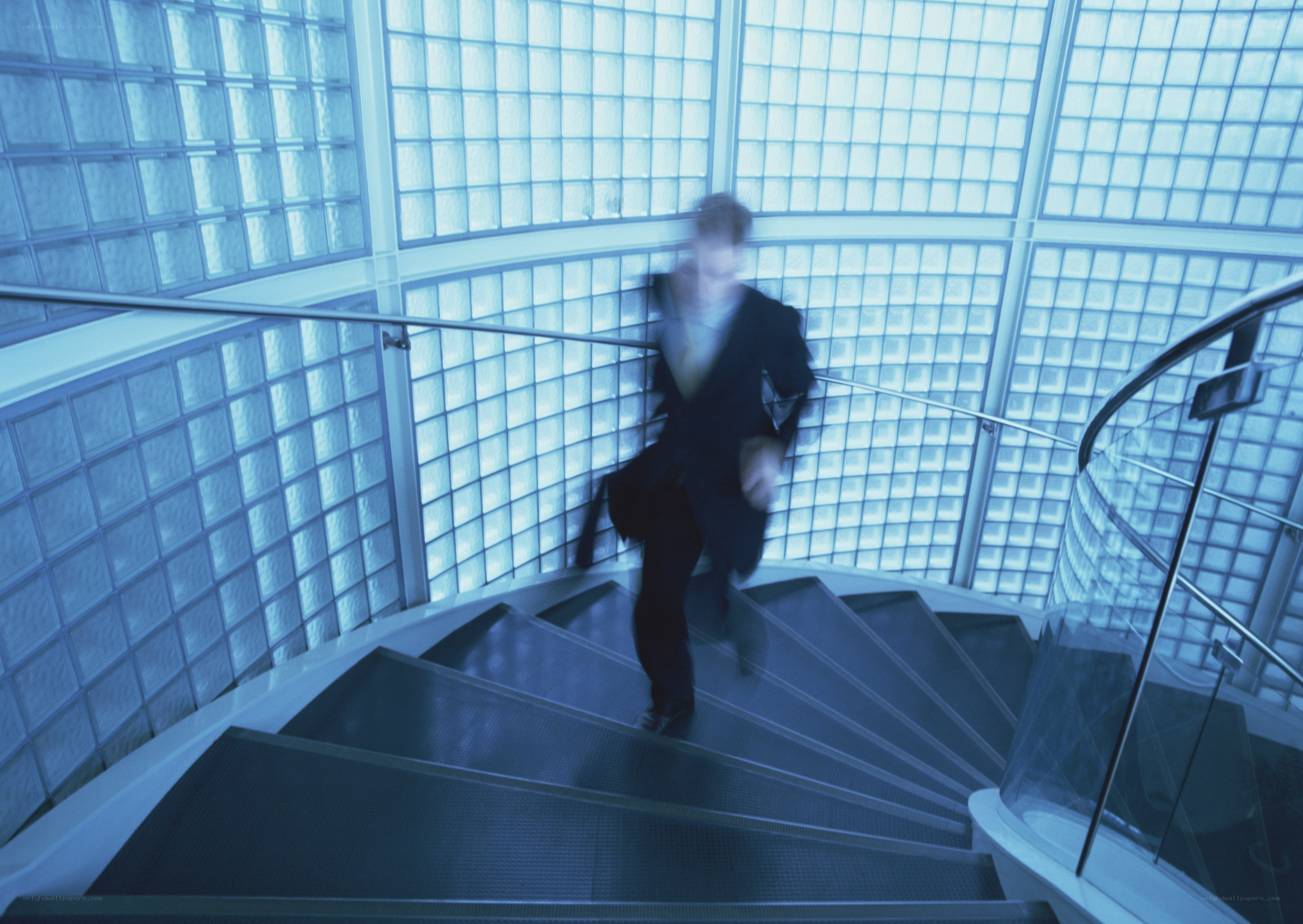 Man running up spiral stairs
