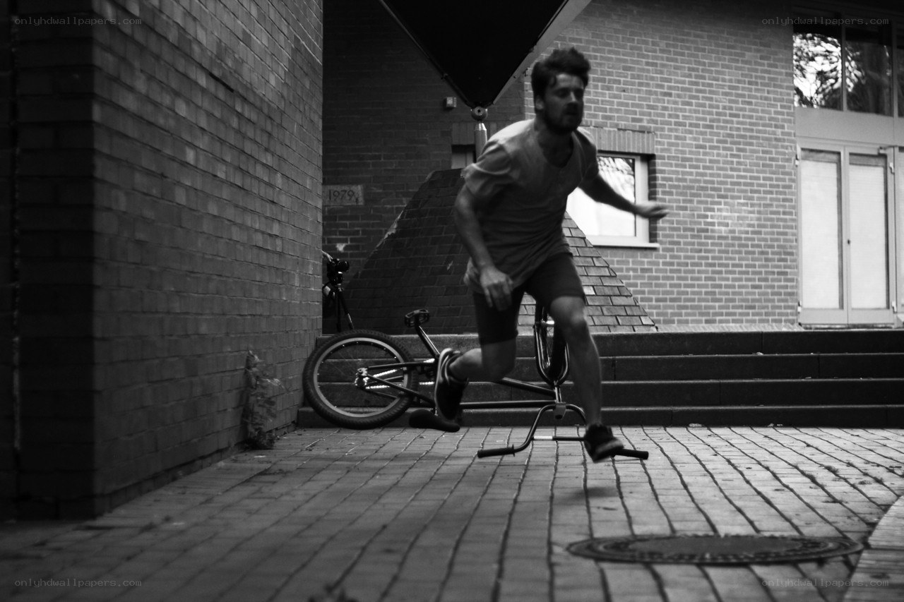 man running with bike