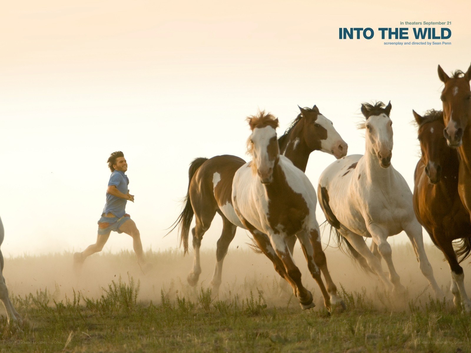 man running with horses