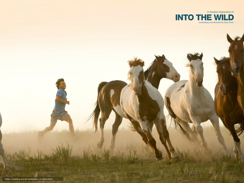 man running with horses