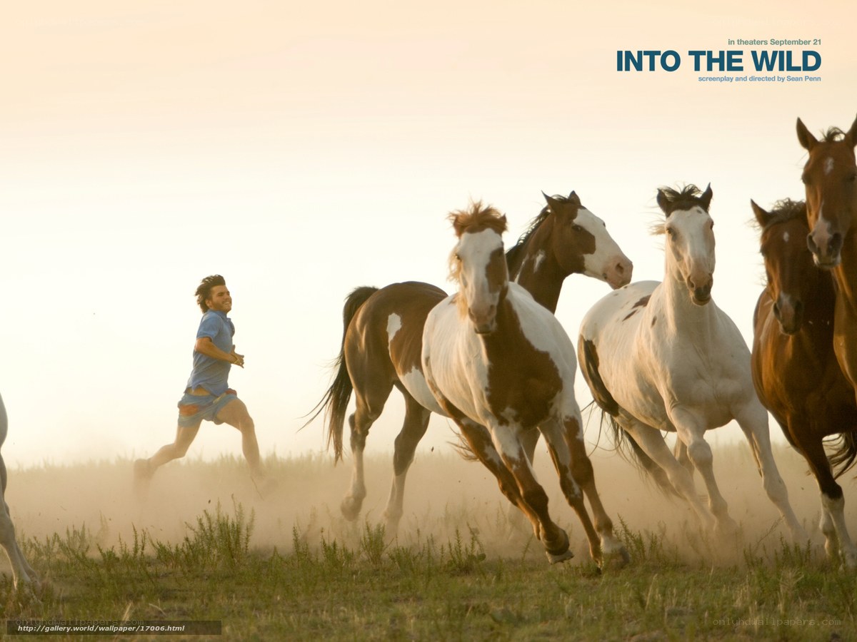 man running with horses