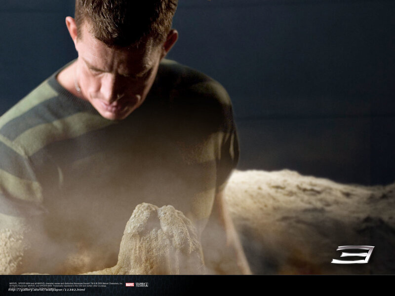 man sculpting sand