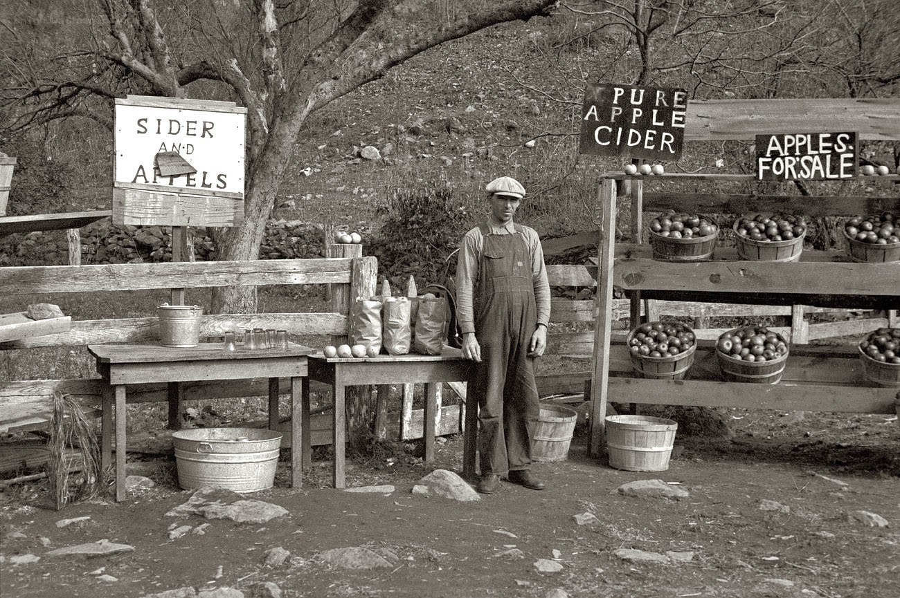 Man selling apples and cider