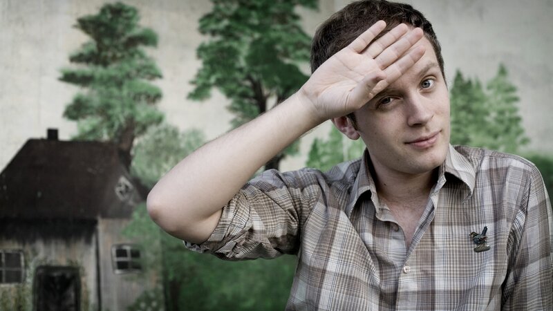 man shading eyes with hand