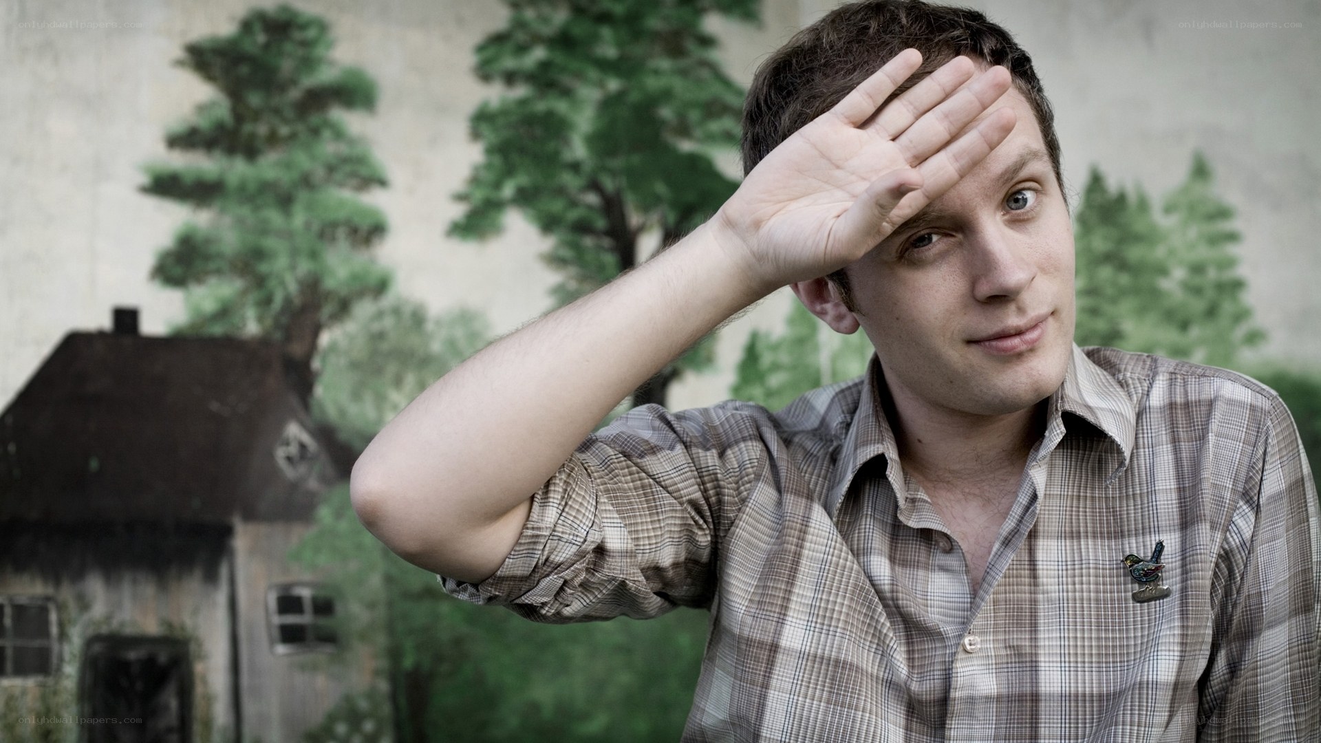man shading eyes with hand