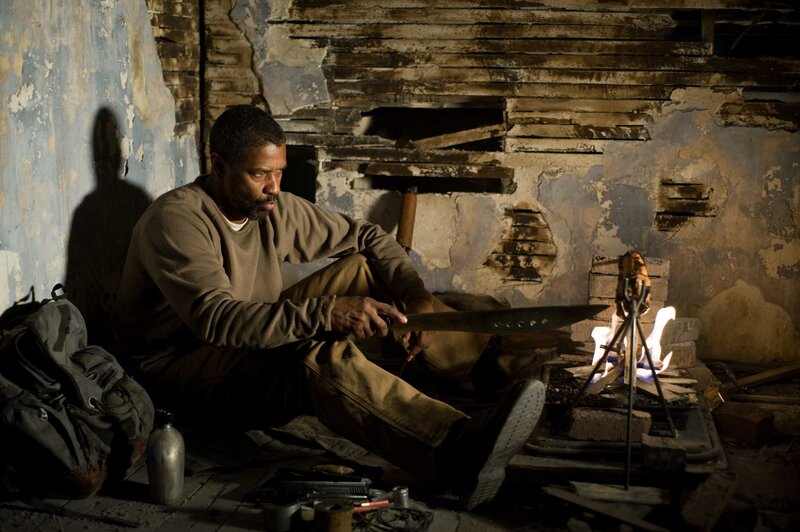 man sharpening knife in ruin