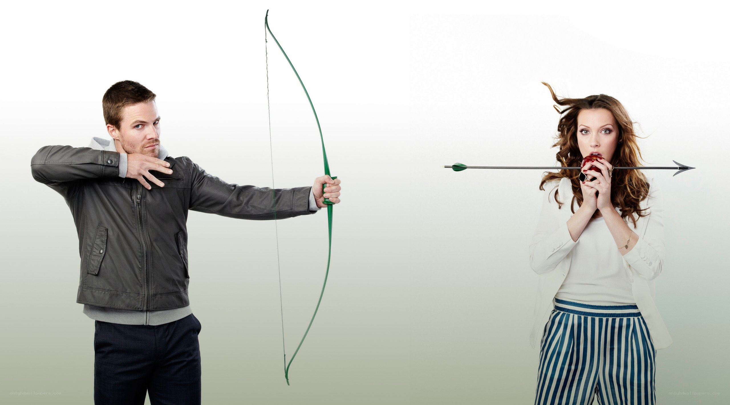 Man shooting arrow at woman