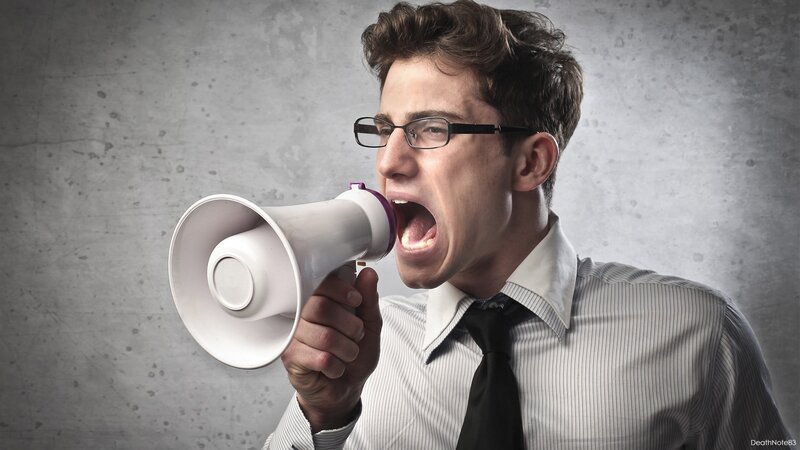 man shouting into megaphone