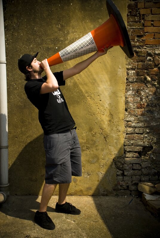man shouting into traffic cone