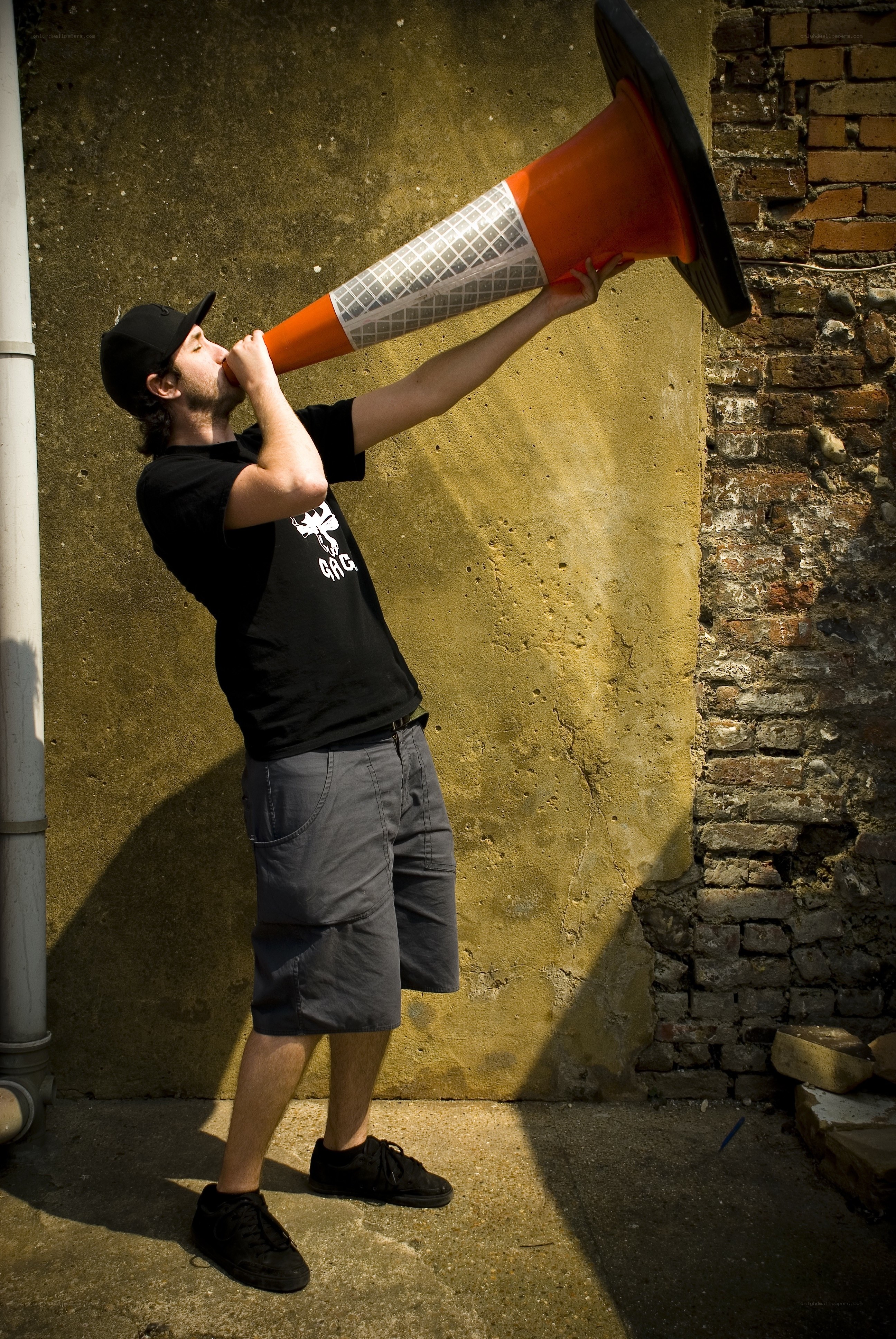 man shouting into traffic cone