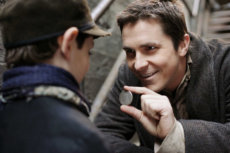 man showing coin to boy