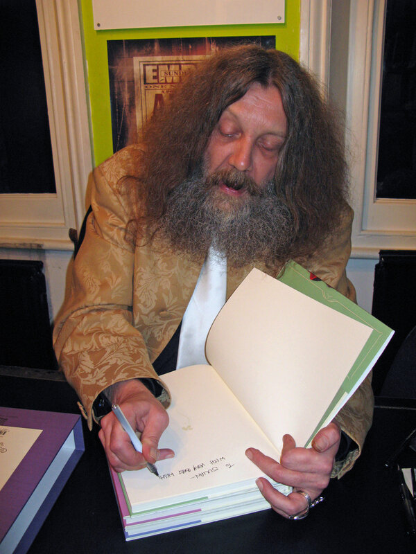 man signing a book