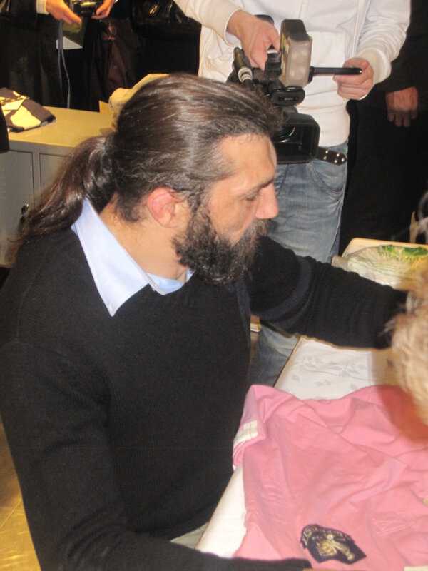 man signing autograph at event