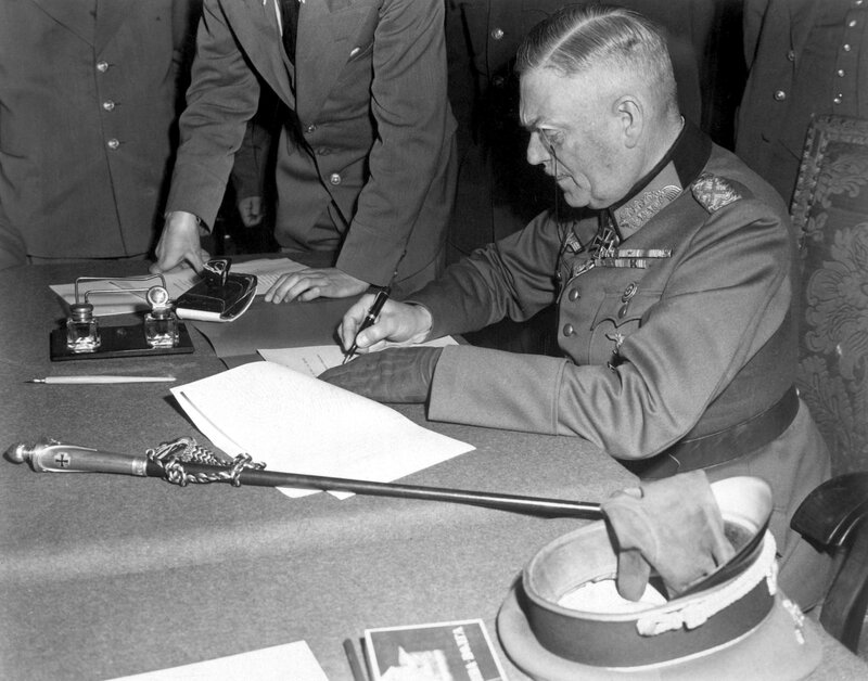 Man signing document at desk