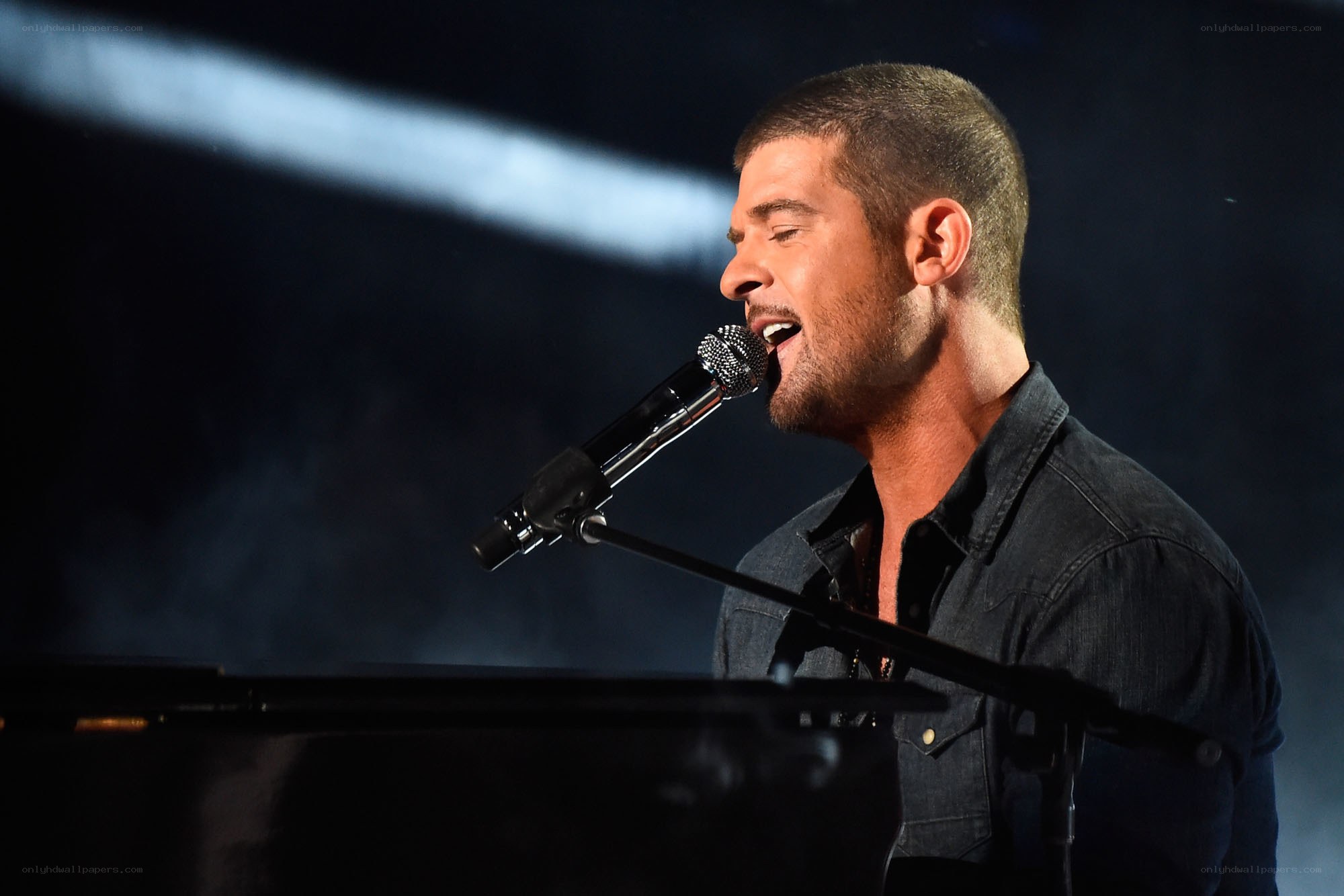 man singing at piano