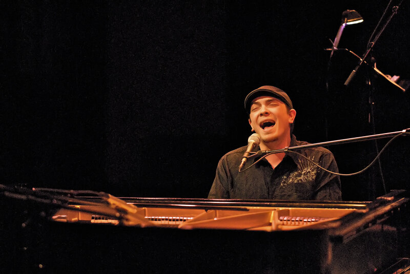 man singing at piano