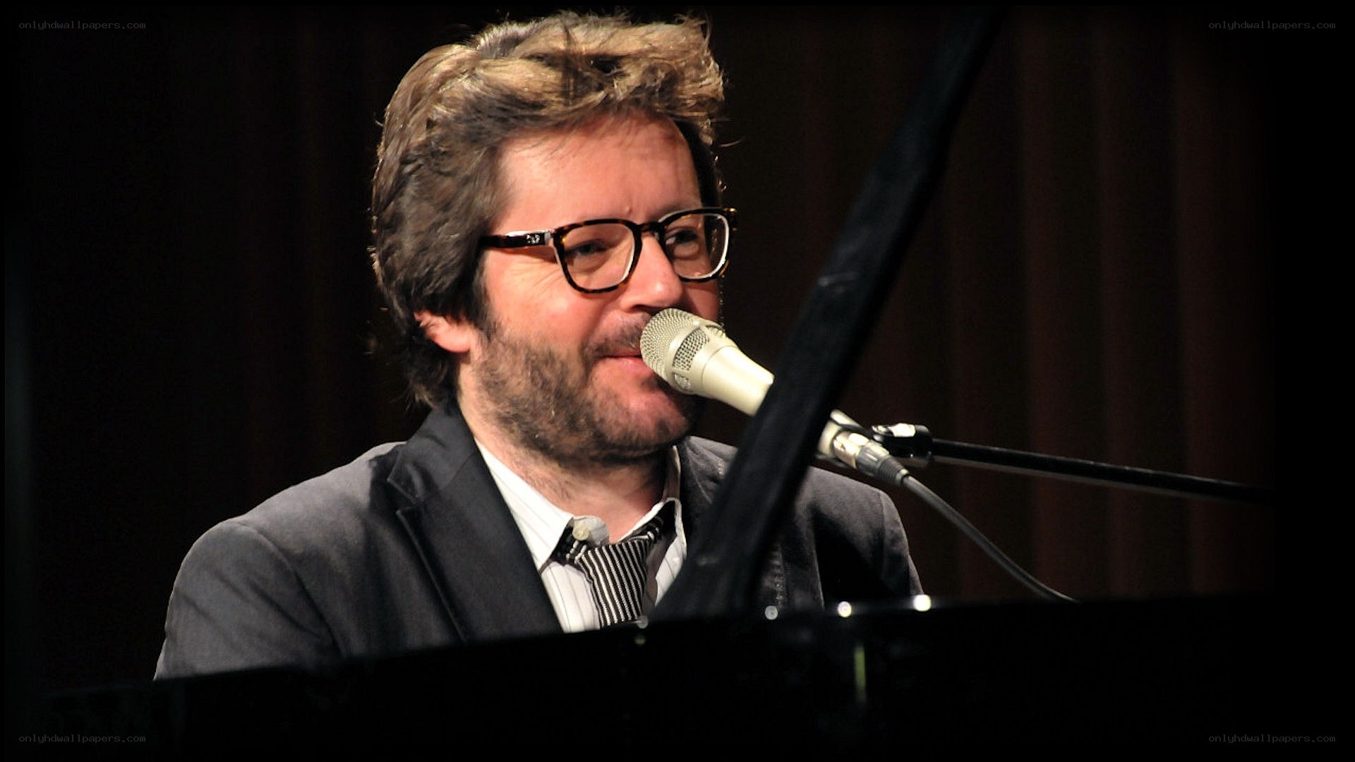 man singing at piano
