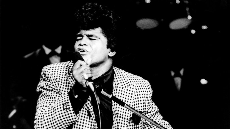 Man Singing into Microphone — Black, Dramatic, Night, Photograph, Checkered Jacket