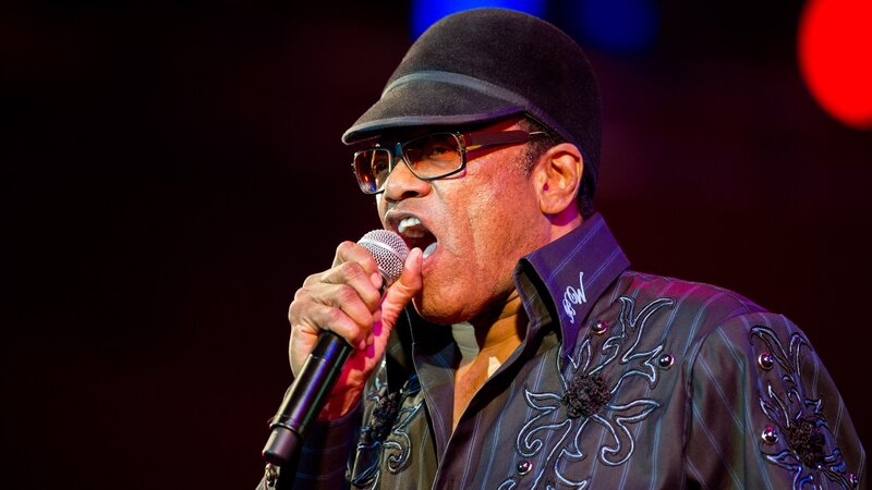 Man Singing into Microphone — Black, Dramatic, Night, Photograph, Hat