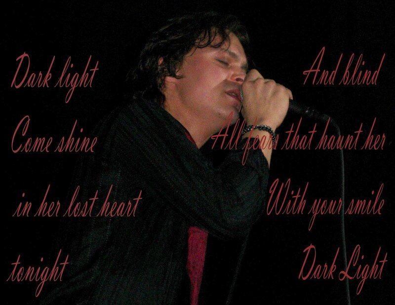 Man Singing into Microphone — Black, Dramatic, Night, Photograph, Scarf