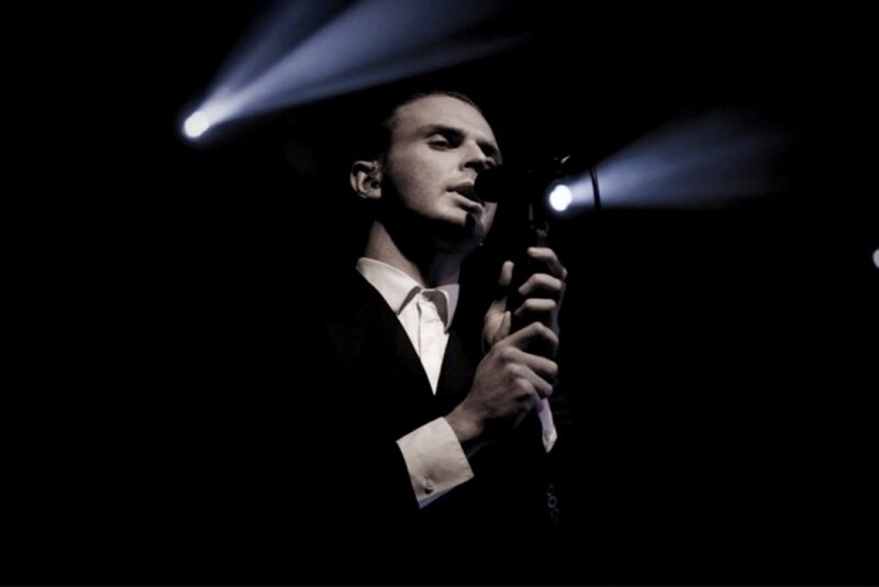 Man Singing into Microphone — Black, Dramatic, Night, Photograph, Spotlight