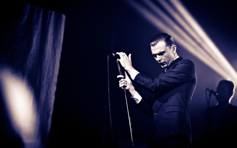 Man Singing into Microphone — Black, Dramatic, Night, Photograph, Suit
