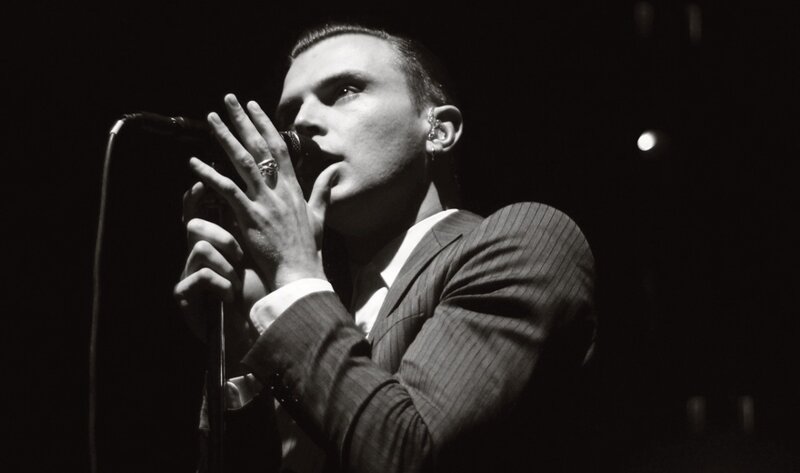 Man Singing into Microphone — Black, Dramatic, Night, Photograph