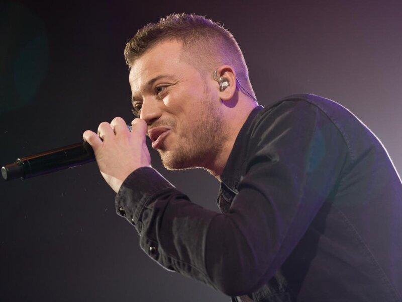 Man Singing into Microphone — Black, Dramatic, Photograph, Earpiece