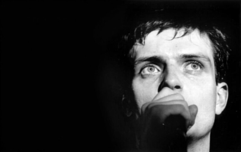 Man Singing into Microphone — Black, Dramatic, Photograph, Face