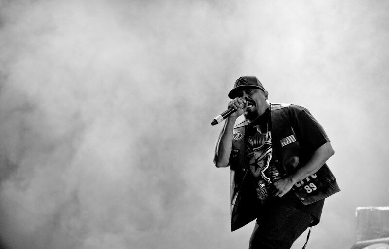 Man Singing into Microphone — Black, Dramatic, Photograph, Hat