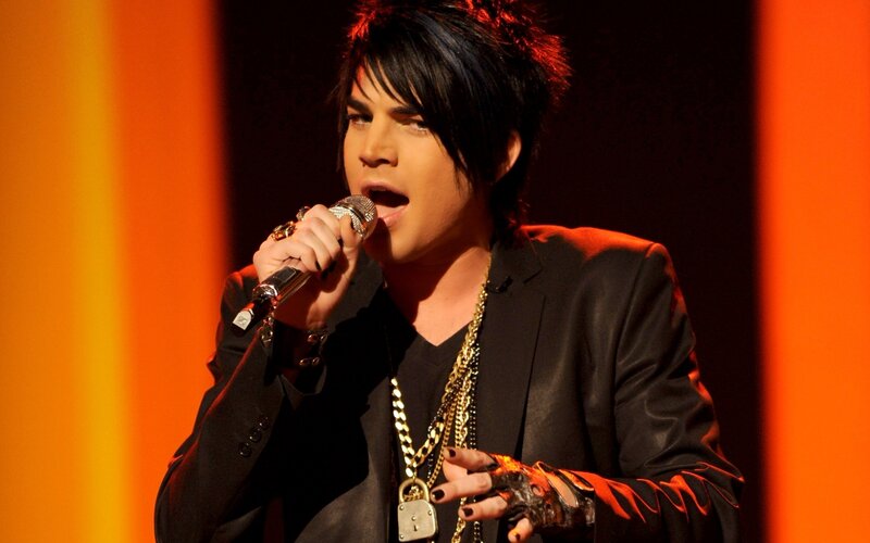 Man Singing into Microphone — Black, Dramatic, Photograph, Jacket, Necklaces