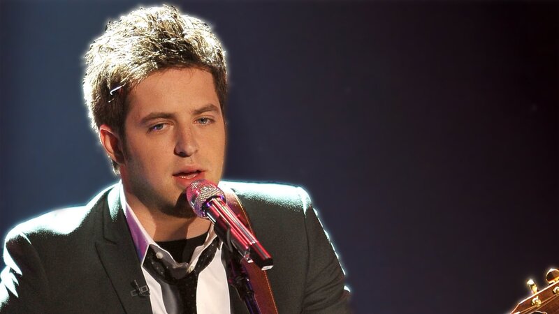 Man Singing into Microphone — Black, Dramatic, Photograph, Suit, Guitar