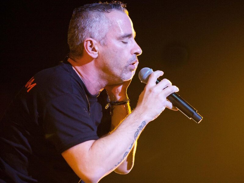 Man Singing into Microphone — Black, Dramatic, Photograph, Tattoo
