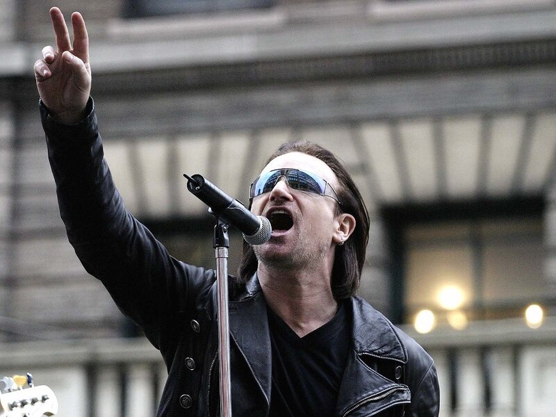 Man Singing into Microphone — Black, Energetic, Photograph, Sunglasses, Leather Jacket