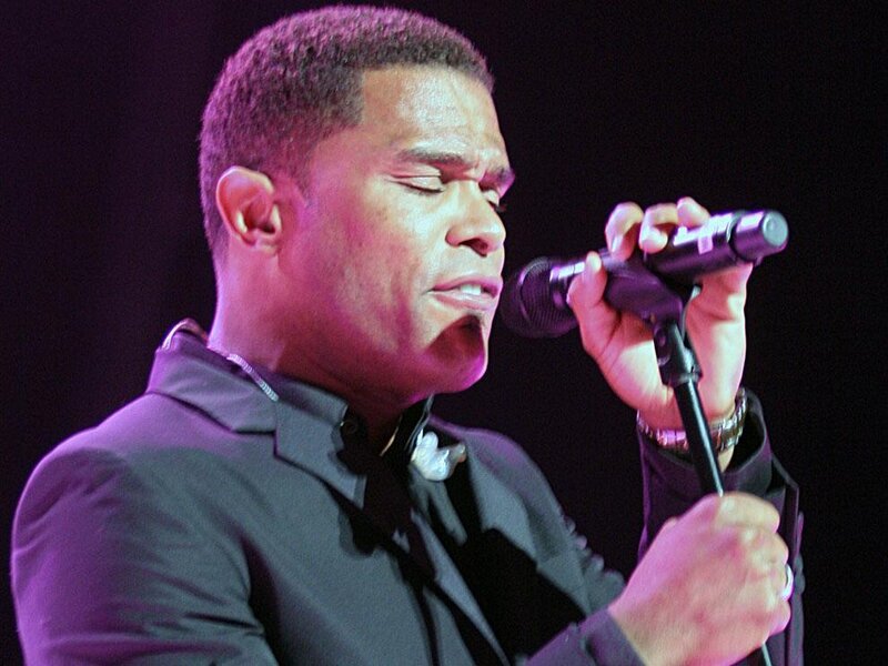 Man Singing into Microphone — Black, Focused, Photograph, Suit